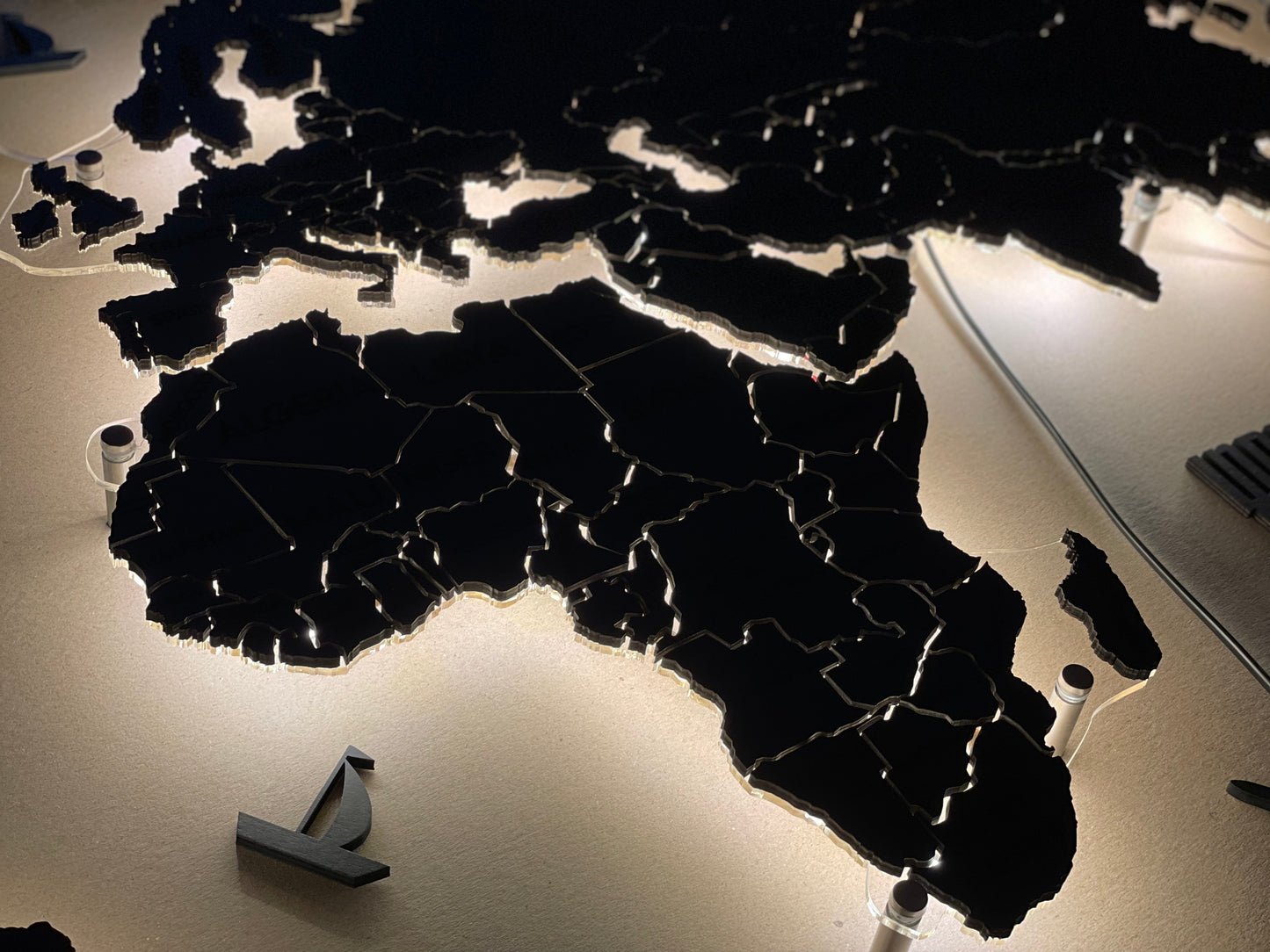 LED world map on acrylic glass with LED lighting between countries color Nero